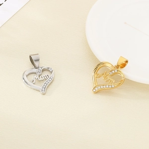 Detail of gold and silver heart pendants with Mom engraving and white rhinestones