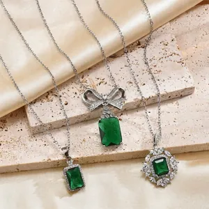 Elegant emerald cut green gemstone necklace set with square and bow pendants in silver plating