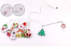 Detail of Christmas LED string lights with snowman and Santa shapes showing USB and battery box