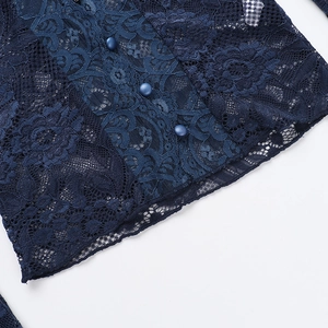 Close-up of navy blue hollow lace texture with matching round decorative buttons