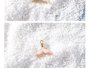 Macro view of colorful mermaid tail charms with pink shells for DIY jewelry making