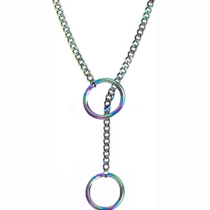 Detail of gothic punk iridescent dual-ring heart pendant on a chunky metal chain
