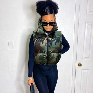 Detail view of camouflage puffer vest with stand collar and zipper closure on model
