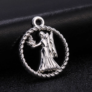Silver alloy round zodiac pendant featuring an intricately engraved winged angel motif
