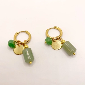 Detail of gold hoops with green natural stone beads and flat metal disk pendants