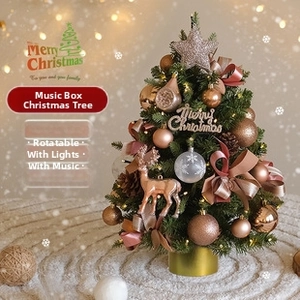 Close-up of musical Christmas tree with champagne baubles and glowing warm lights