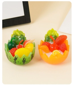 Detailed view of miniature fruit bowl charms featuring resin watermelon and orange designs