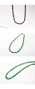 Macro detail of natural tiger eye and green stone beaded necklace with gold spacers