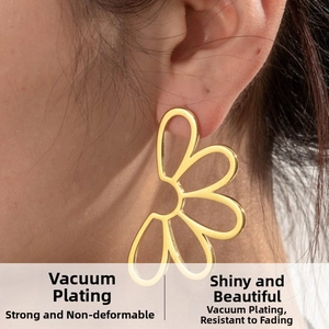 Macro shot of large hollow daisy stud earring in gold-plated stainless steel on ear