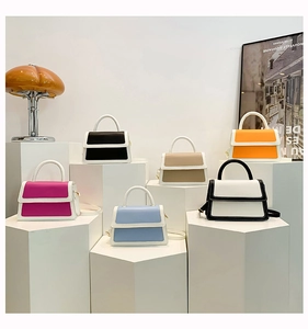 Group display of mini contrast leather handbags in six colors on geometric steps
