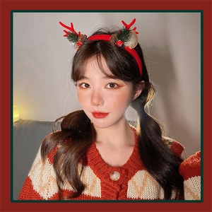 Christmas reindeer antler headband with pine cones and mushrooms on a model in warm light