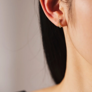 Elegant s925 sterling silver gold plated asymmetric zircon stud earrings worn by a model