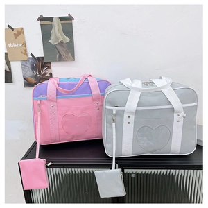 Pink and grey JK uniform bags with heart-shaped clear windows and matching purses