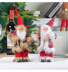 Detail of Santa Claus figurines with miniature gift bags in a cozy festive setting