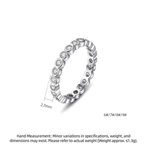 Minimalist silver eternity band ring with 2.7mm round bezel-set cubic zirconia stones