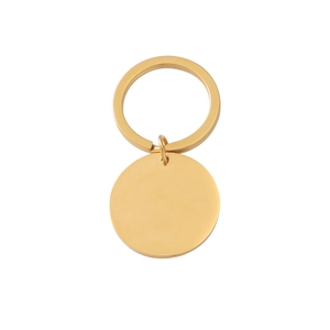 Close-up of golden stainless steel mirror-finish round pendant with flat key ring
