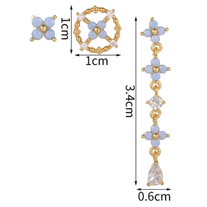 Detailed view of light blue orchid stud earrings set with golden tassels and zircon accents