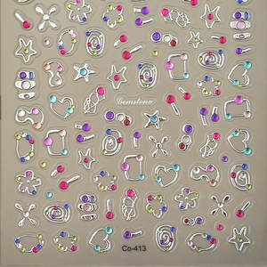 3D metallic gemstone nail art stickers with stars and hearts on a grey background
