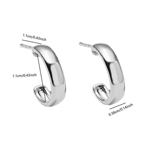 Detail view of silver C-shaped stud earrings showing 1.1cm height and polished finish