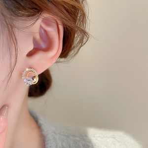 Close-up of elegant gold plated double hoop earrings with cubic zirconia on model ear