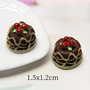 Macro shot of miniature chocolate resin cake with red berries for dollhouse DIY
