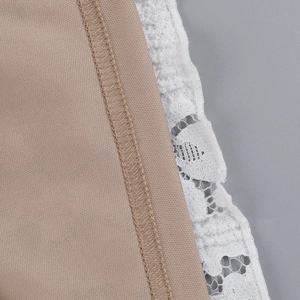 Detail of khaki plain fabric joined with white lace featuring fine floral embroidery