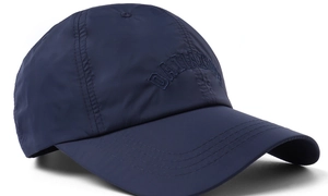 Detail view of navy baseball cap featuring breathable fabric texture and reinforced stitching