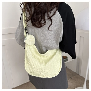 Detail of yellow seersucker crossbody bag with adjustable strap and fashion coin purse