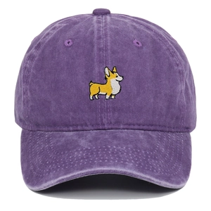 Close-up of Corgi dog embroidery on a purple washed cotton baseball cap with fabric texture