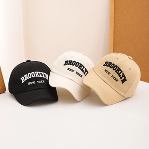 Classic Brooklyn New York embroidered baseball caps for kids in black, cream, and khaki