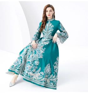 Détail de l'imprimé floral cachemire et de la ceinture sur une robe longue vert foncé