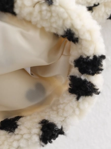Detailed macro view of heart pattern fleece fabric with soft beige textile lining