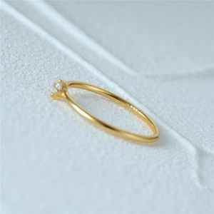 Macro shot of S925 hallmark on minimalist 18K gold plated silver slim zircon ring