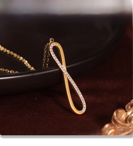 Macro shot of gold infinity pendant with PVD plating and sparkling cubic zirconia stones