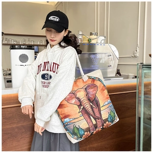 Detail of canvas tote bag with elephant floral pattern and sturdy white rope handles
