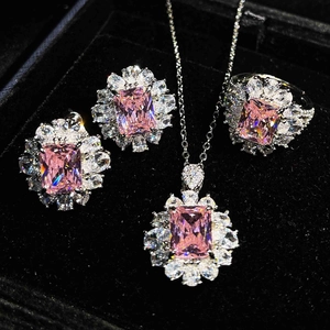 Close-up of pink rectangular gemstones in jewelry set within a black velvet box