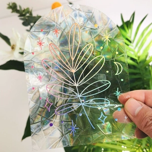 Close-up of rainbow prism window film with leaf patterns reflecting colorful light