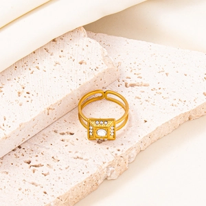 Detailed close-up of a golden double-layer stainless steel ring with a square zircon inlay