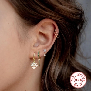 Minimalist S925 sterling silver gold ear cuff set with green zircon on model ear