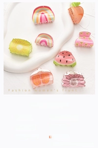 Detail of colorful acrylic hair clips in fruit shapes with matte texture and size specs