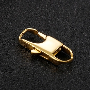 Polished gold stainless steel lobster clasp for necklaces and bracelets on black background