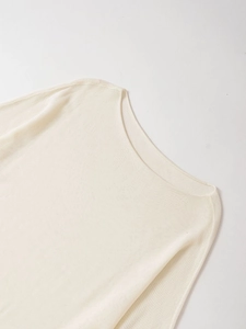 Detail of boat neck seam on cream white lightweight knit sweater with smooth stitching