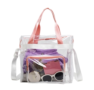Detailed view of clear PVC tote bag with pink handles showing large storage capacity
