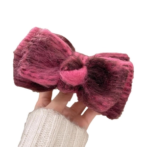 Plush acrylic bow hair claw clip in magenta and purple color contrast for daily wear