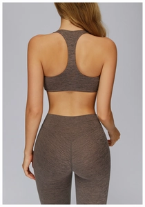 Detail of racerback sports bra and high-waisted leggings in brown heathered fabric