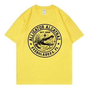 Detail of a bright yellow crew neck t-shirt featuring a black alligator graphic print