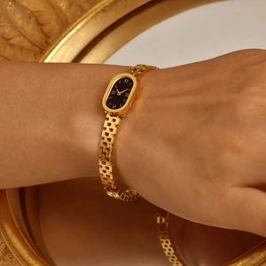 Vintage gold stainless steel watch bracelet with black oval dial and Roman numerals for women