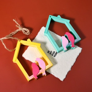 Artistic bird house wooden pendant with colorful painted birds and hemp rope hanging detail