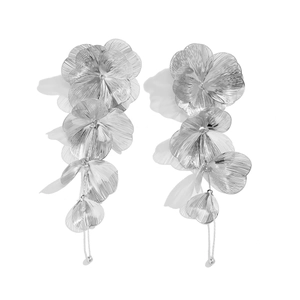 Detail of silver ginkgo leaf earrings with fine radial texture and long tassel chain