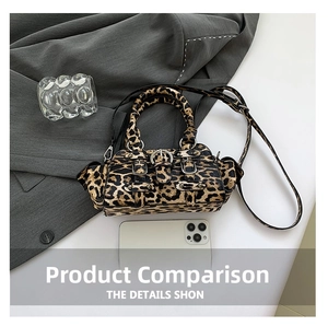 Detail view of leopard print Boston bag with silver buckle straps and side pleated pocket